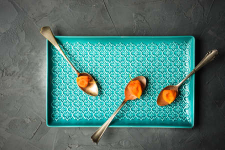 Autumnal table setting with bright yellow leaves and physalis  on old wooden table with copyspaceの写真素材