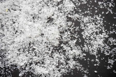 Festive Christmas concept with snow and decoration on rustic flatlay and frame with copyspaceの写真素材