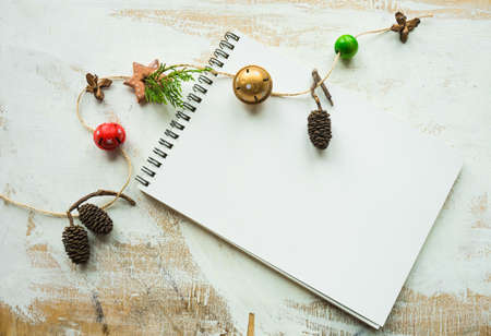 Festive Christmas concept with snow and decoration on rustic flatlay and frame with copyspace