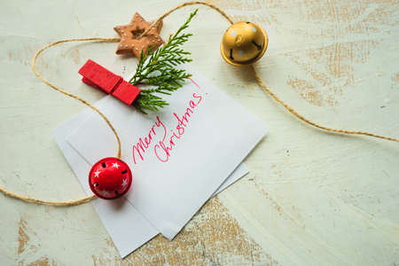 Festive Christmas concept with snow and decoration on rustic flatlay and frame with copyspaceの写真素材