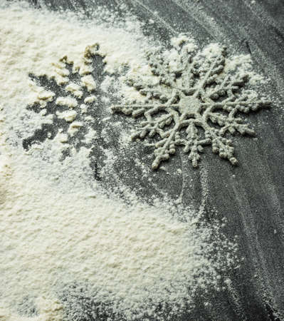 Cooking concept with cookies forms and flour on dark wooden table with copyspaceの写真素材