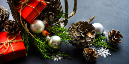 Festive Christmas concept with snow and decoration on rustic flatlay and frame with copyspaceの写真素材