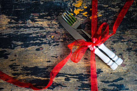 Festive table setting for Christmas dinner on vintage wooden table with copyspaceの写真素材