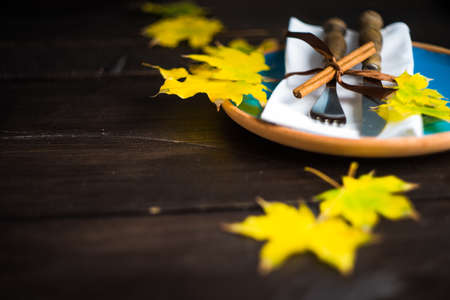 Autumnal table setting with bright red and orange wild berries on rustic background with copyspaceの写真素材