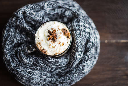 Autumnal concept with bright yellow leaves and cup of coffee  in rustic style with copyspaceの写真素材