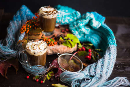 Autumnal concept with bright yellow leaves and cup of coffee  in rustic style with copyspaceの写真素材
