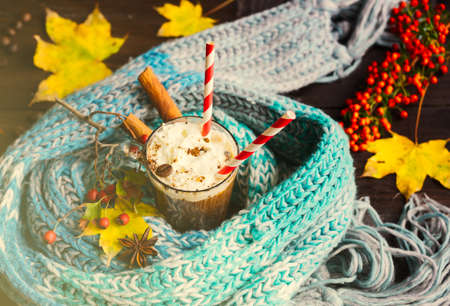 Autumnal concept with bright yellow leaves and cup of coffee  in rustic style with copyspaceの写真素材