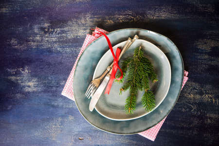 Festive table setting for holiday Christmas dinner on rustic background with copy spaceの写真素材