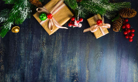 Christmas concept with gift boxes, ribbon and cones on rustic concrete background with copyspaceの写真素材