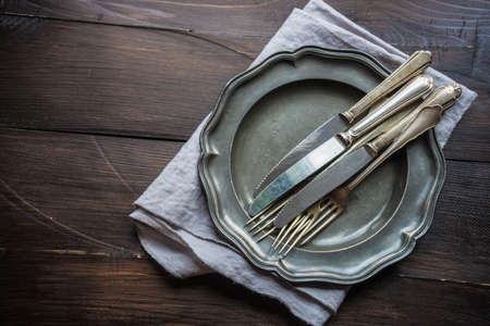Rustic table setting on vintage wooden table with copyspaceの写真素材