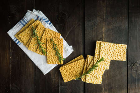Healthy concept with homemade crackers bread on dark wooden tableの写真素材