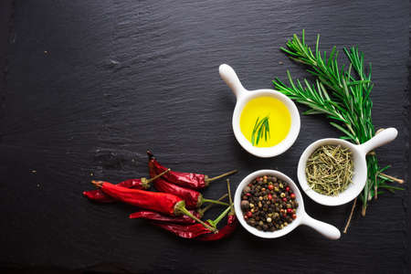 Cooking concept with vintage tableware and spices on old wooden table with copyspaceの写真素材