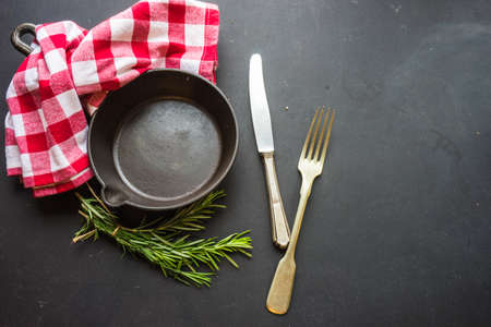 Cooking concept with vintage tableware and spices on old wooden table with copyspaceの写真素材