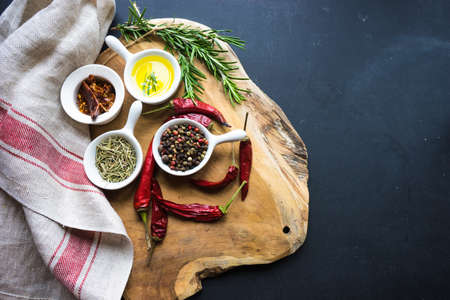 Cooking concept with vintage tableware and spices on old wooden table with copyspace