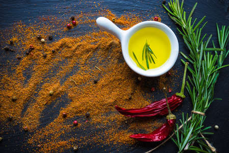 Cooking concept with vintage tableware and spices on old wooden table with copyspace