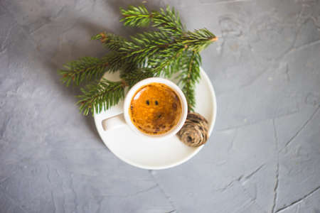 Cup of coffee with chocolate cookies and Christmas decoration on grey concrete background with copy spaceの写真素材