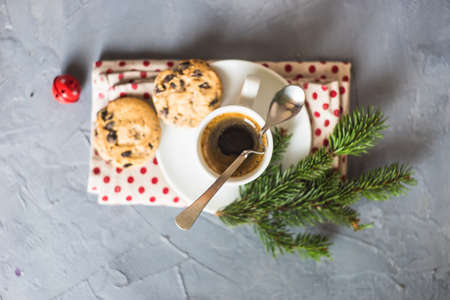 Cup of coffee with chocolate cookies and Christmas decoration on grey concrete background with copy spaceの写真素材