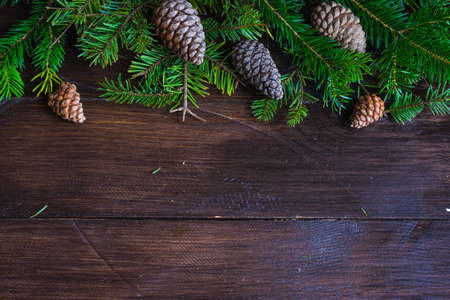 Christmas holiday flat lay with Christmas fir tree and cones on rustic backgroundの写真素材