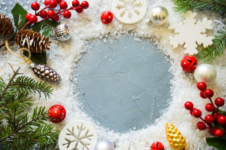 Christmas holiday flat lay with snow, fir tree and berries on rustic backgroundの写真素材