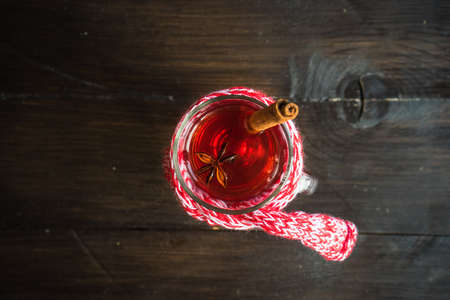 Mulled wine in a glass on rustic wooden tableの写真素材