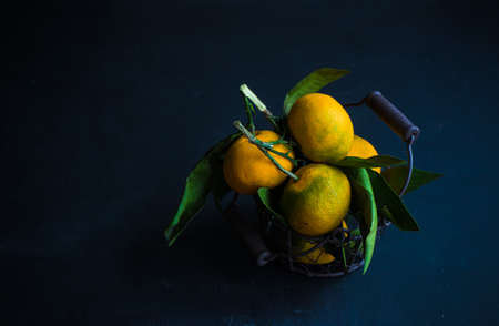 Fresh organic tangerine fruits on rustic wooden table and copyspaceの写真素材