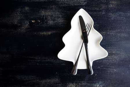 Rustic table setting for festive Christmas dinner with vintage decor on concrete grey backgroundの写真素材