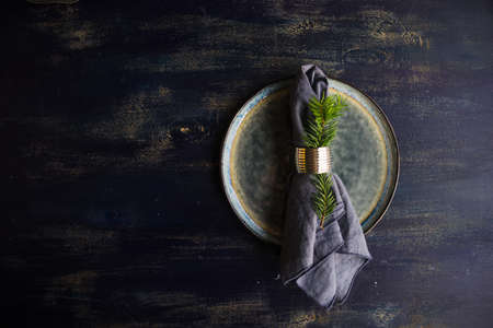 Rustic table setting for festive Christmas dinner with vintage decor on concrete grey backgroundの写真素材