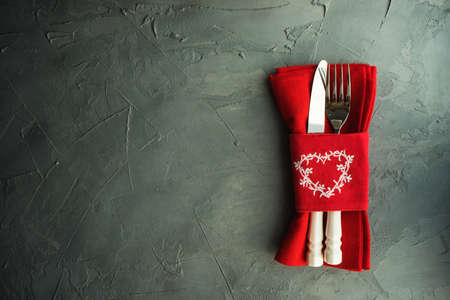Rustic table setting for festive  dinner in Valentines Day with vintage heart-shaped decor on concrete grey backgroundの写真素材