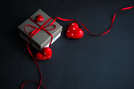 Gifts with heart shaped decor on grey concrete background with copyspaceの写真素材
