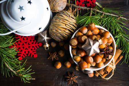 Christmas holiday concept with fir tree, cones, nuts and decoration on rustic background with copyspaceの写真素材
