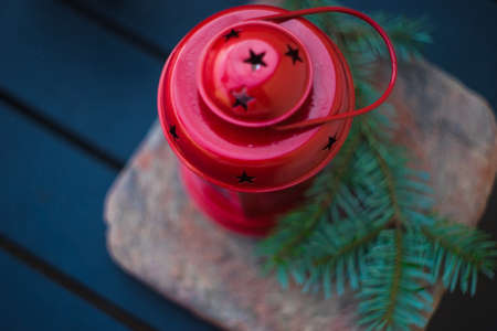 Christmas holiday concept with fir tree, decoration and red vintage lamp on rustic background with copyspaceの写真素材