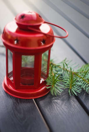 Christmas holiday concept with fir tree, decoration and red vintage lamp on rustic background with copyspaceの写真素材