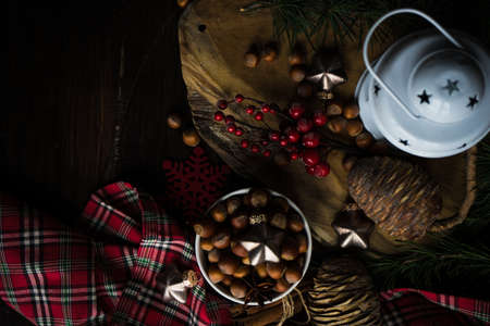 Christmas holiday concept with fir tree, cones, nuts and decoration on rustic background with copyspaceの写真素材