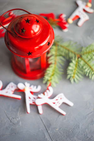 Christmas holiday concept with fir tree, decoration and red vintage lamp on rustic background with copyspaceの写真素材