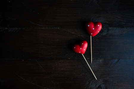 St. Valentines Day concept with hearts on rustic dark wooden background with copyspaceの写真素材