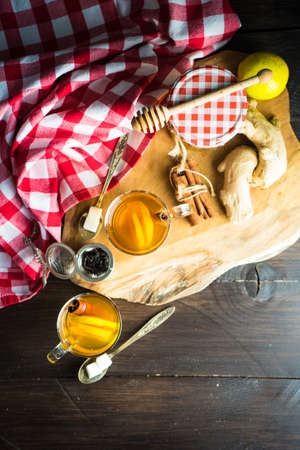 Cup of tea with ginger, lemon and honey on rustic wooden table with copyspaceの写真素材