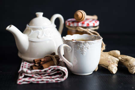 Cup of tea with ginger, lemon and honey on rustic wooden table with copyspaceの写真素材