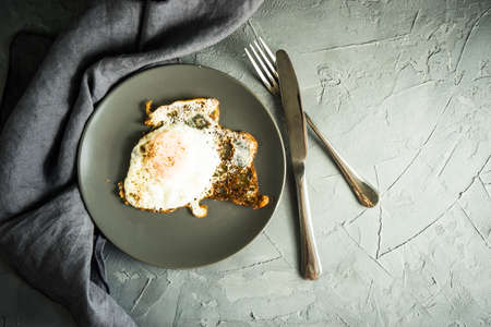 Traditional european breakfast with fried eggs on rustic plateの写真素材