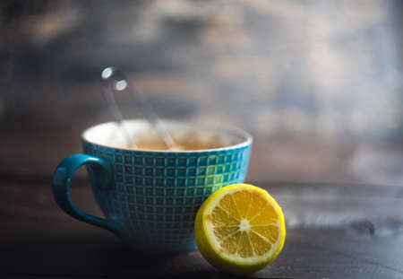 Cup of tea with lemon on dark wooden table with copyspaceの写真素材