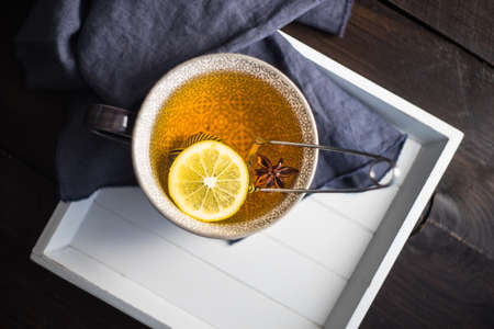 Cup of tea with lemon on dark wooden table with copyspaceの写真素材