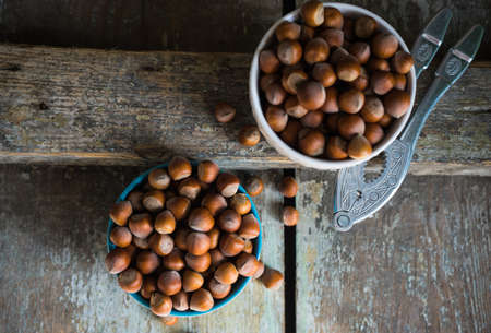 Organic nuts in a bowls on rustic wooden background as a healthy food conceptの写真素材