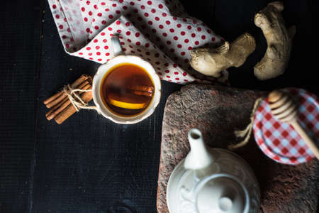 Cup of tea with ginger, lemon and honey on rustic wooden table with copyspaceの写真素材