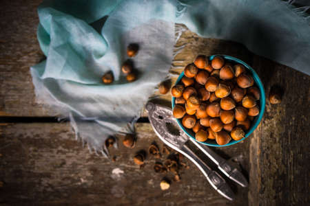 Organic nuts in a bowls on rustic wooden background as a healthy food conceptの写真素材