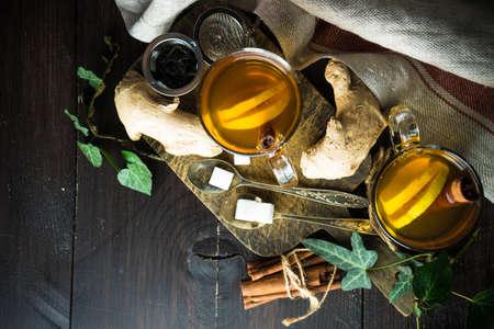 Cup of tea with ginger, lemon and honey on rustic wooden table with copyspaceの写真素材
