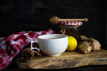 Cup of tea with ginger, lemon and honey on rustic wooden table with copyspaceの写真素材