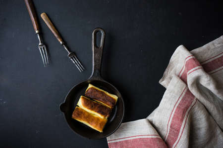 Stuffed pancakes crepes with meat and cream sauce on dark wooden table with copyspaceの写真素材