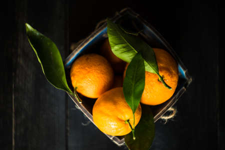 Ripe organic tangerines on rustic  wooden table with copyspaceの写真素材