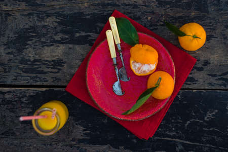 Ripe tangerines and bottle of fresh tangerines juice on rustic background with copyspaceの写真素材