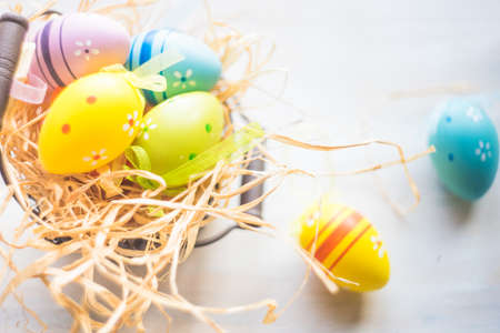 Easter holiday concept with colored easter eggs on wooden background with copyspaceの写真素材