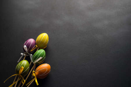 Easter holiday concept with colored easter eggs on wooden background with copyspaceの写真素材